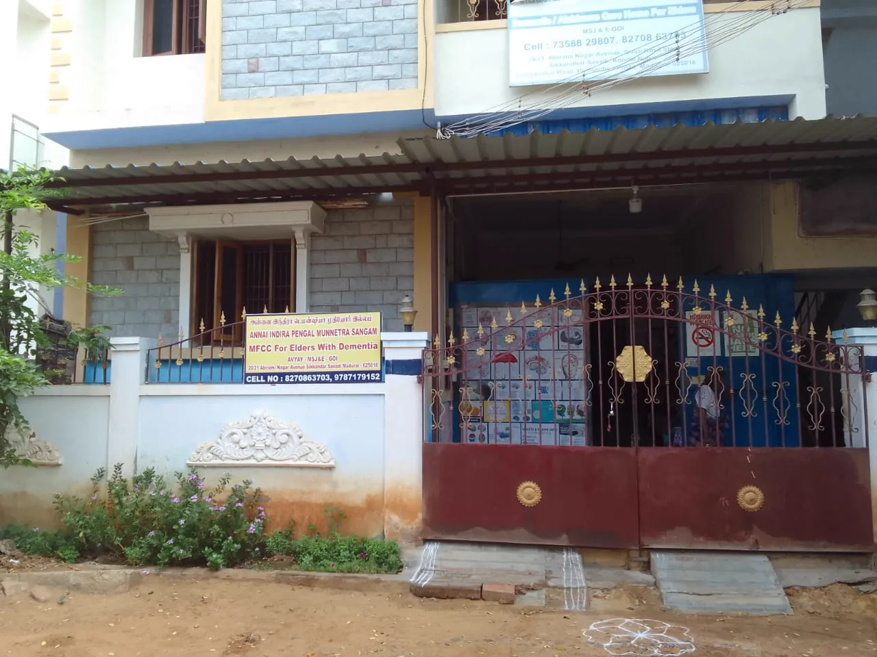 Older women and caregivers together outside the AIPMS home in Madurai